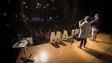 PoetrySlam Performance auf der B&uuml;hne vor Publikum